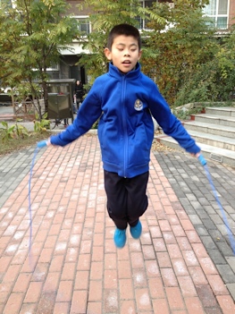 Young boy skipping rope