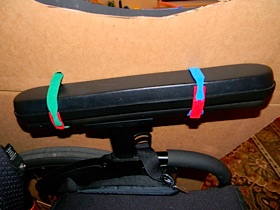 attaching the horse to the wheelchair with velcro ties