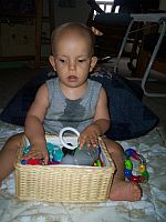Ivan feeling all the toys in his toy basket.