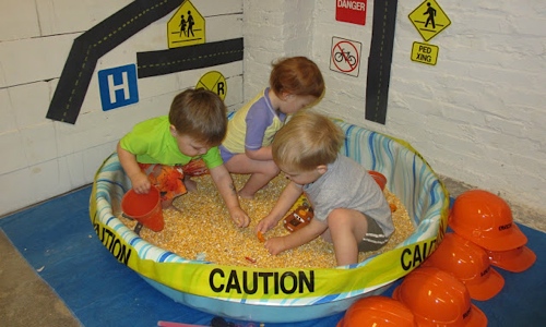 Kids playing in a large sensory bin