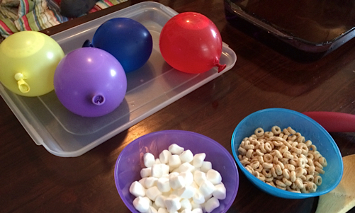 things you'll need for your snow table: water balloons, warm water, spoons, marshmallows, cheerios