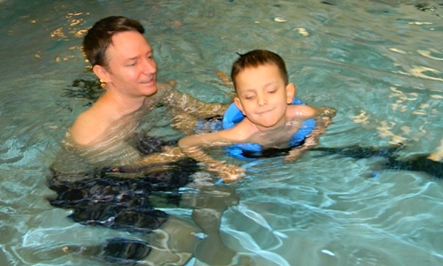 Ivan swimming with his dad