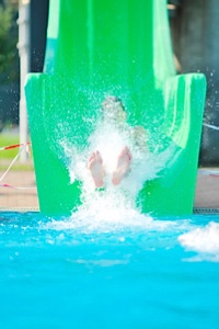 Little girl going down a water slide