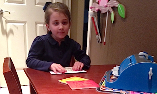 young girl reading braille