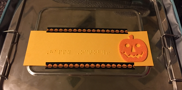 A braille note saying Happy October