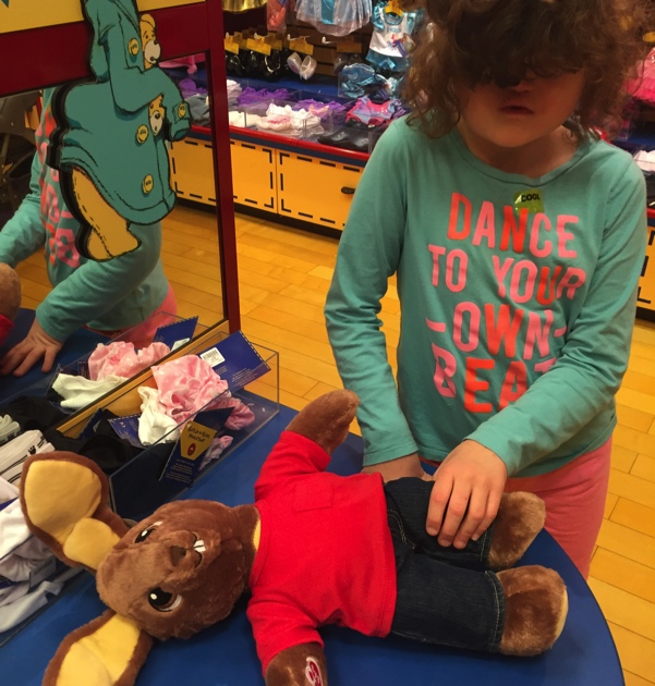 Madilyn picking out clothes for her bunny