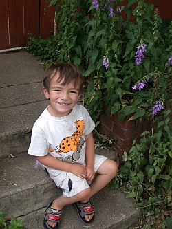 Happy Ethan sitting on the steps.