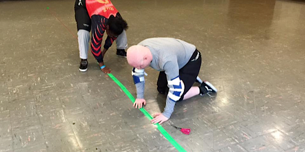 laying down the string and tape for goalball