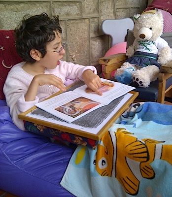 little girl reading with Helen