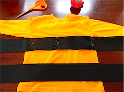 sewing the black stripes to the yellow shirt