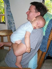 Dad rocks Ivan to sleep.