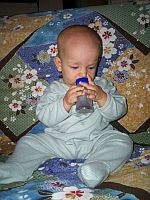 Ivan smelling his scented rattle.