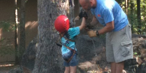 climbing a rope at camp