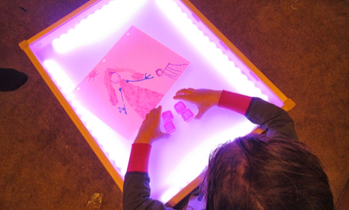 playing at a light table