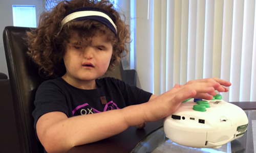 young girl using a braille label maker