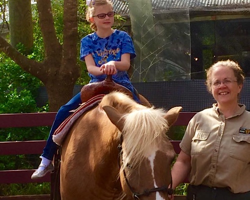 Mary Rose riding a pony at the Dallas Zoo