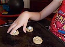 Ivan placing one candy on the cookie