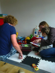 Ronan reading a book with his mom