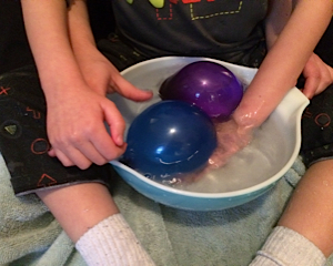 touching the balloons in the water