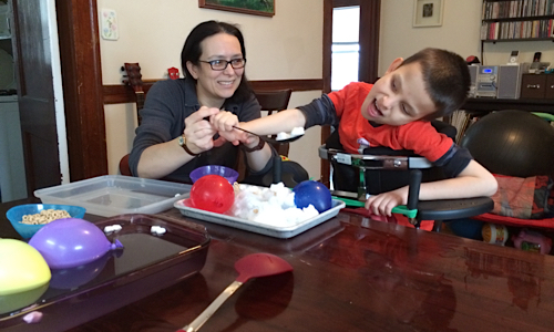 Ivan and mom playing with the snow table