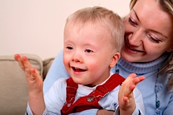 A little boy claps to the beat.