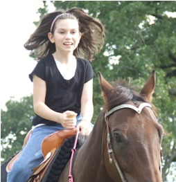 Tacey riding a horse.