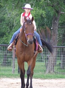 Tacey riding a horse.