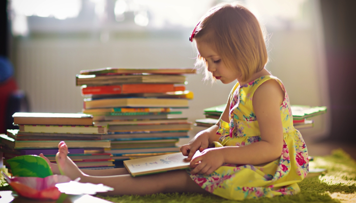 little girl reading a book