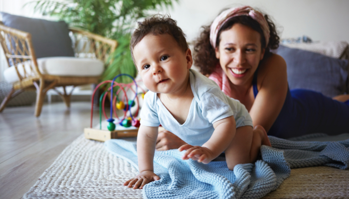 mom watching baby crawl