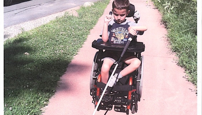 Ivan with his cane in his wheelchair