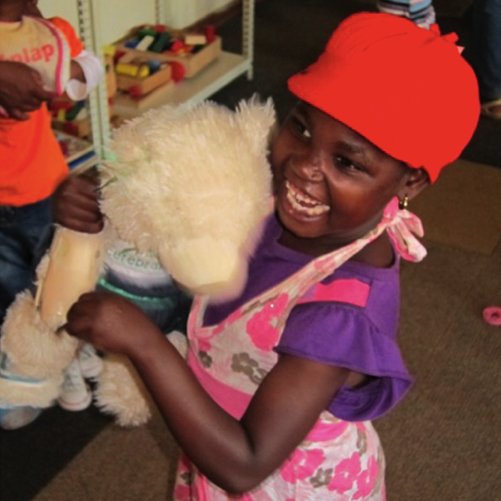 little girl hugging her Aware Bear