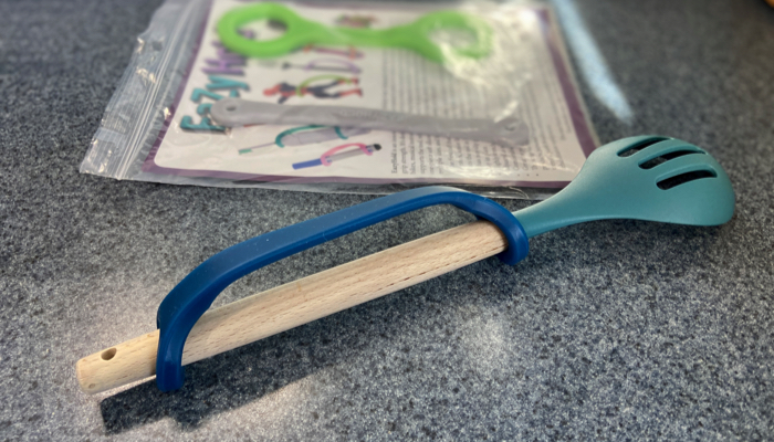 Blue strap EazyHold on a mixing spoon.