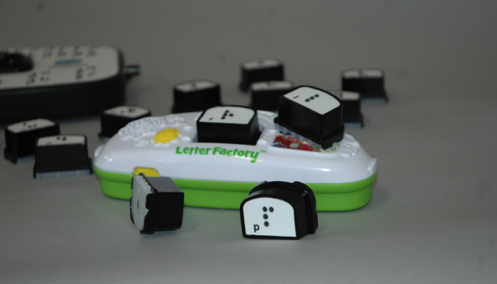 Leapfrog alphabet device with braille letter pieces