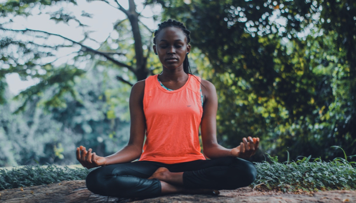 woman meditating outdoors