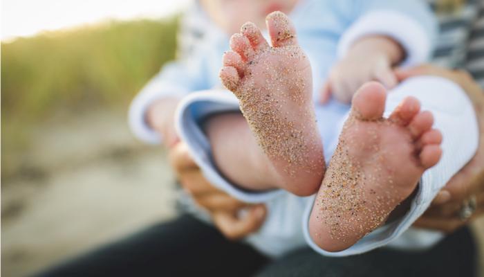 baby feet with sand