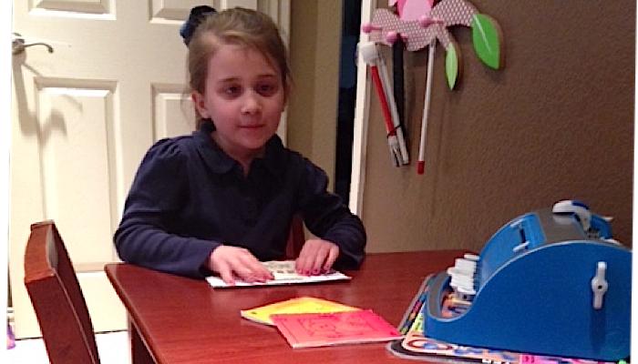 Blind girl reading in braille