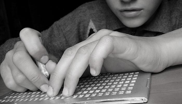 boy using a slate and stylus