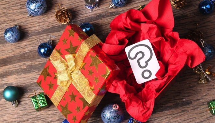 an open Christmas present with a question mark inside