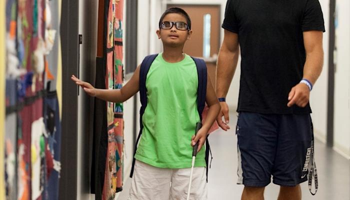 blind student walking at school