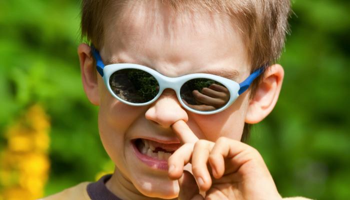 boy picking his nose