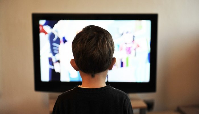 child in front of television