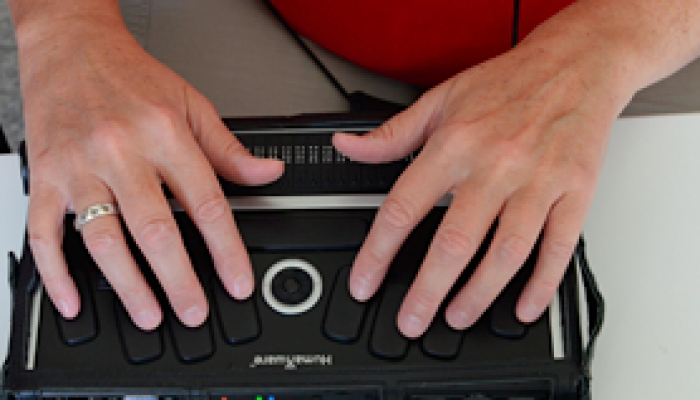 A man using a brailler