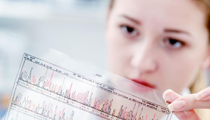 female doctor examining DNA code
