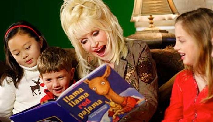 Dolly Parton with a little girl reading a braille book