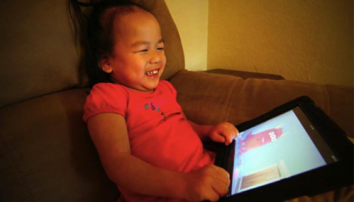 little girl using an iPad