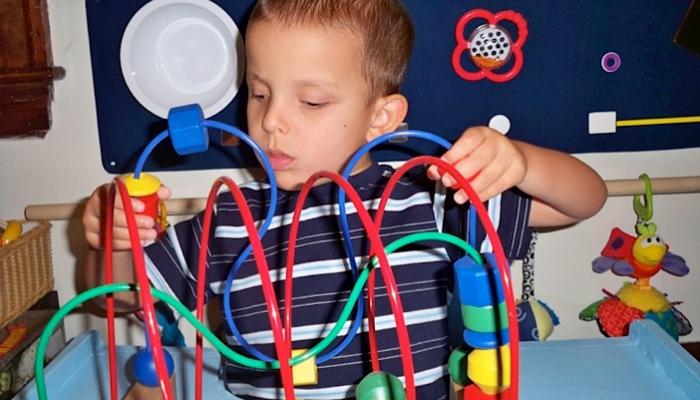 Ivan playing with Bead Maze