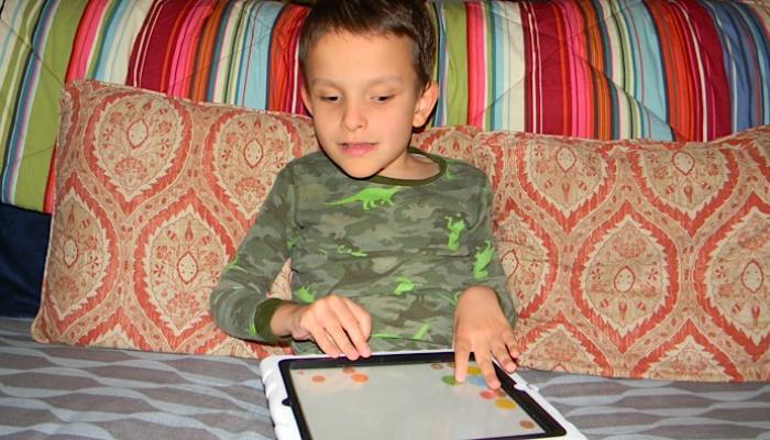 Ivan playing on his iPad