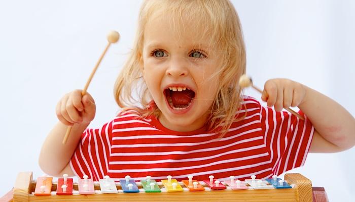 Child playing an xylophone