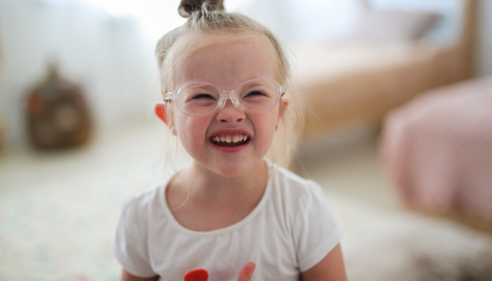 A little girl wearing glasses.