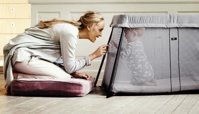 Mom with Baby Bjorn Travel Crib